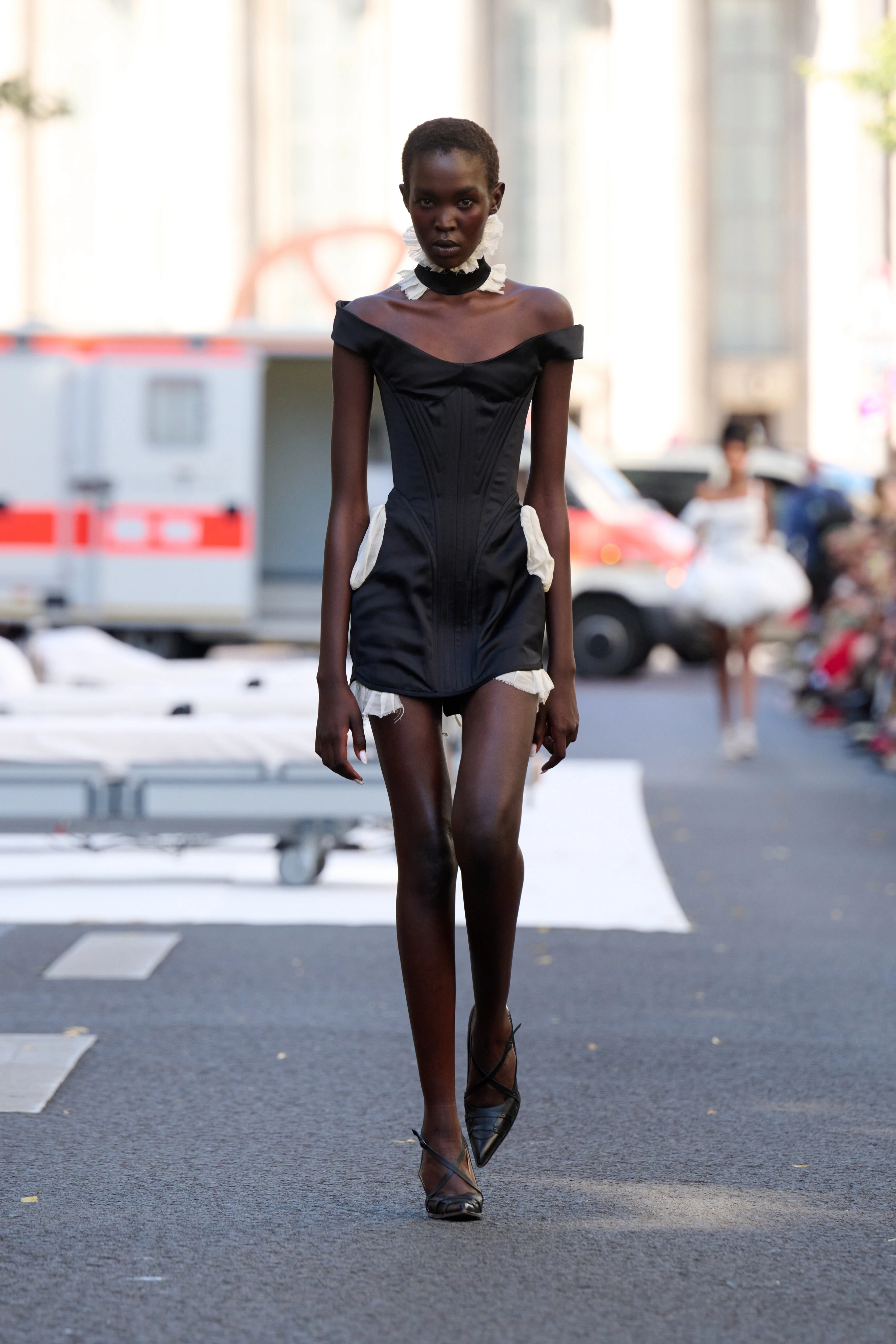 Black off the shoulder dress from Clara Colette Miramon SS26 collection at Berlin Fashion Week worn by a model.