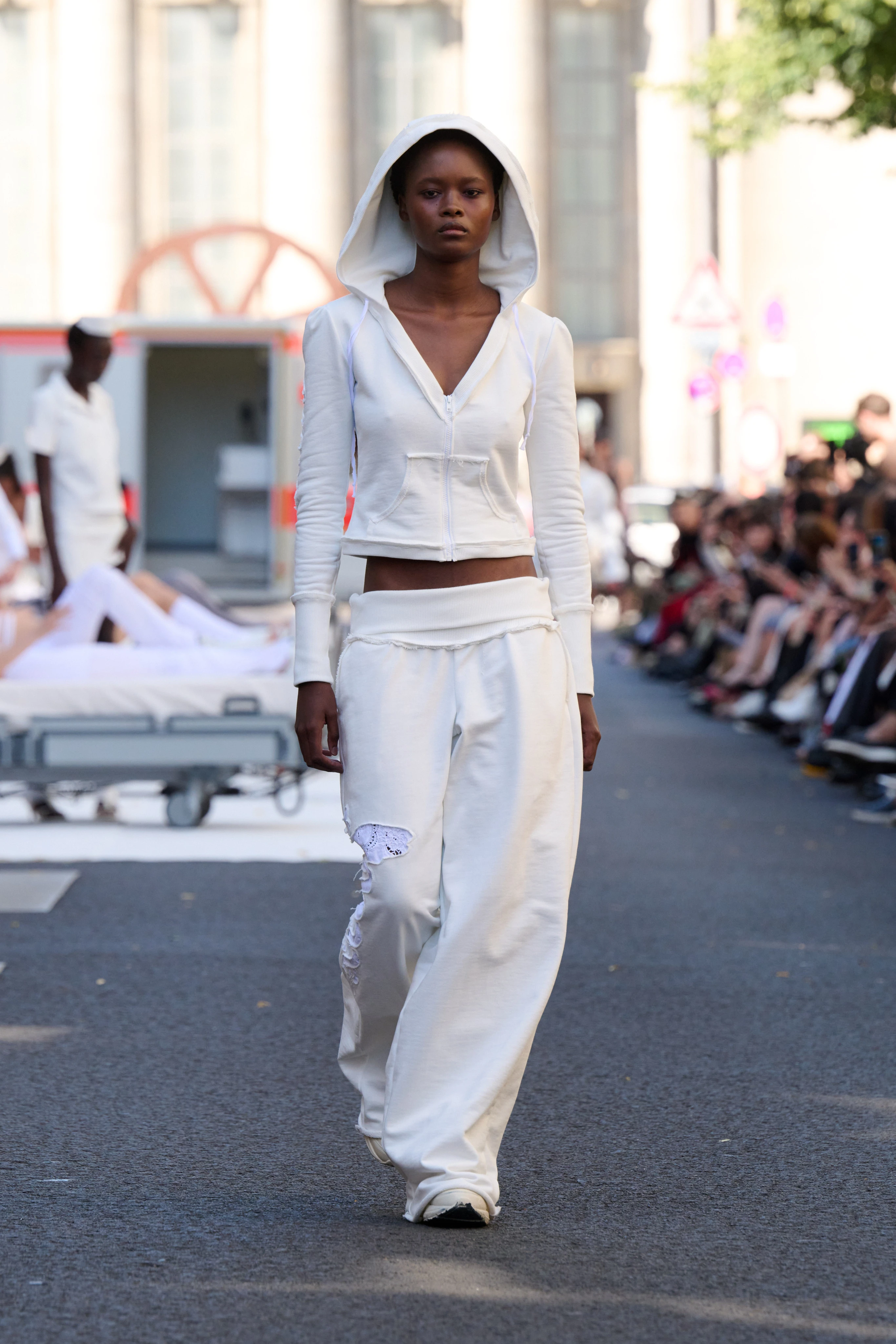 White sweater jacket and loose fit pants from Clara Colette Miramon SS26 collection at Berlin Fashion Week worn by a model.